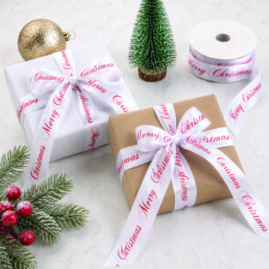 Custom printed Christmas ribbon wrapped around premium gift boxes with personalised Merry Christmas satin ribbon for festive gift packaging.