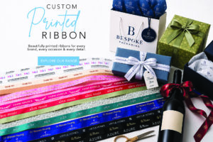Custom printed ribbon samples with gift boxes, wine bottle, premium packaging and branded satin ribbon by Bespoke Packaging.